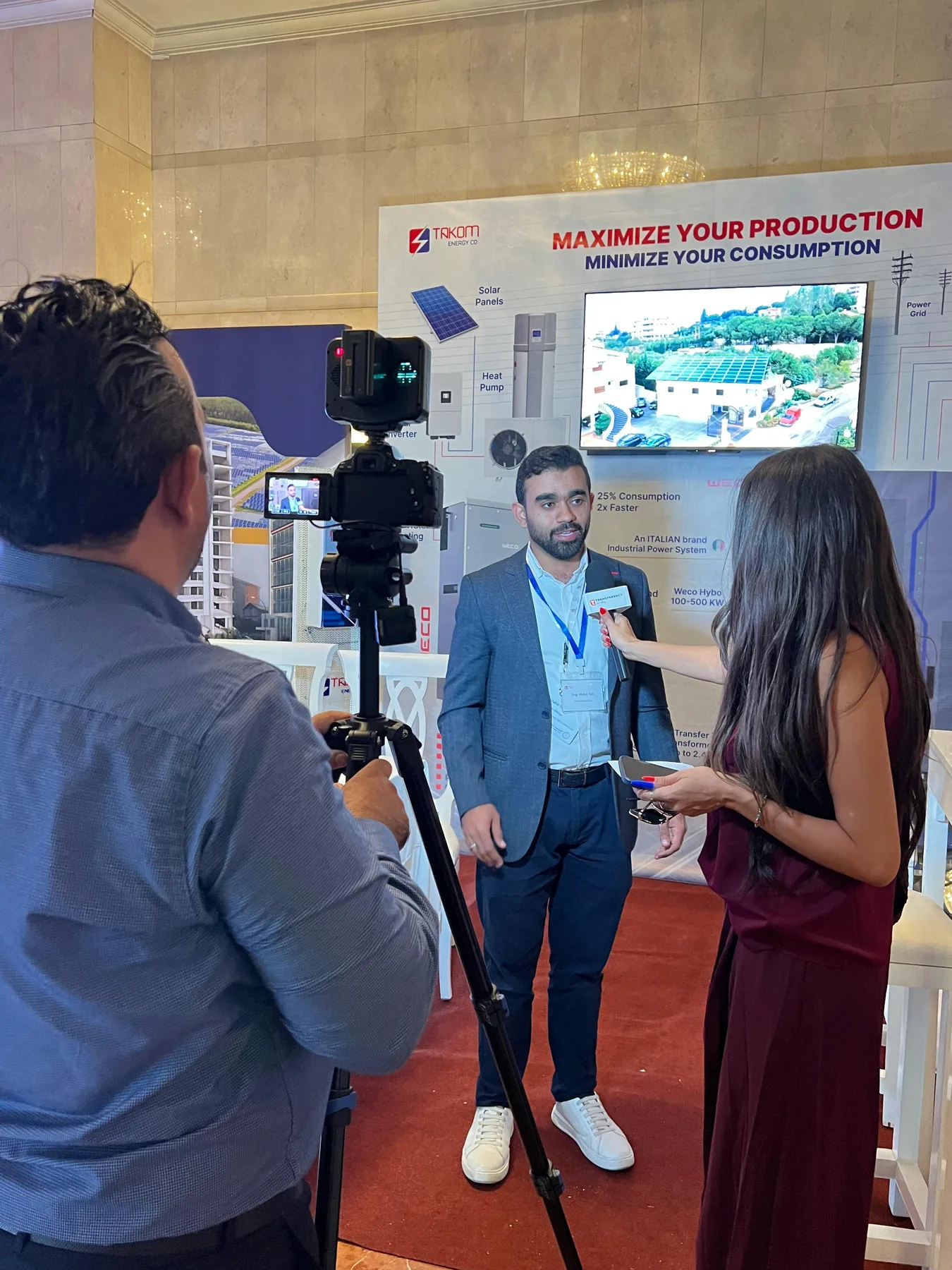 Takom Energy team member during a media interview at the event
